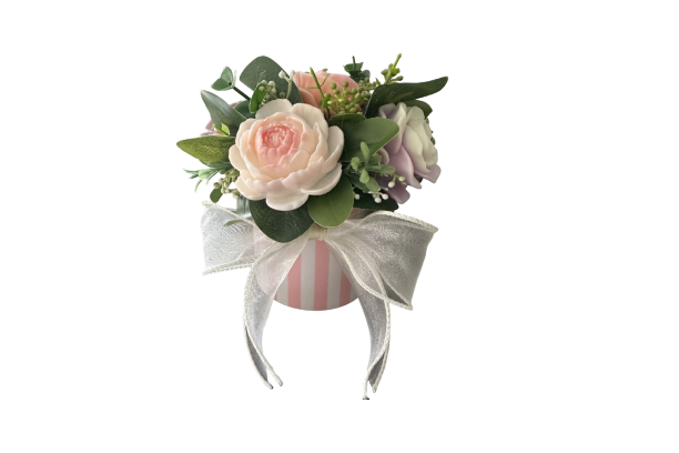 Pink and white floral arrangement with bow