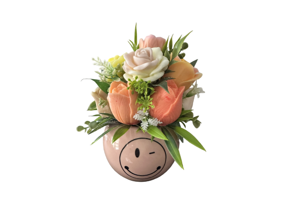 Winking smiley vase with pastel floral bouquet