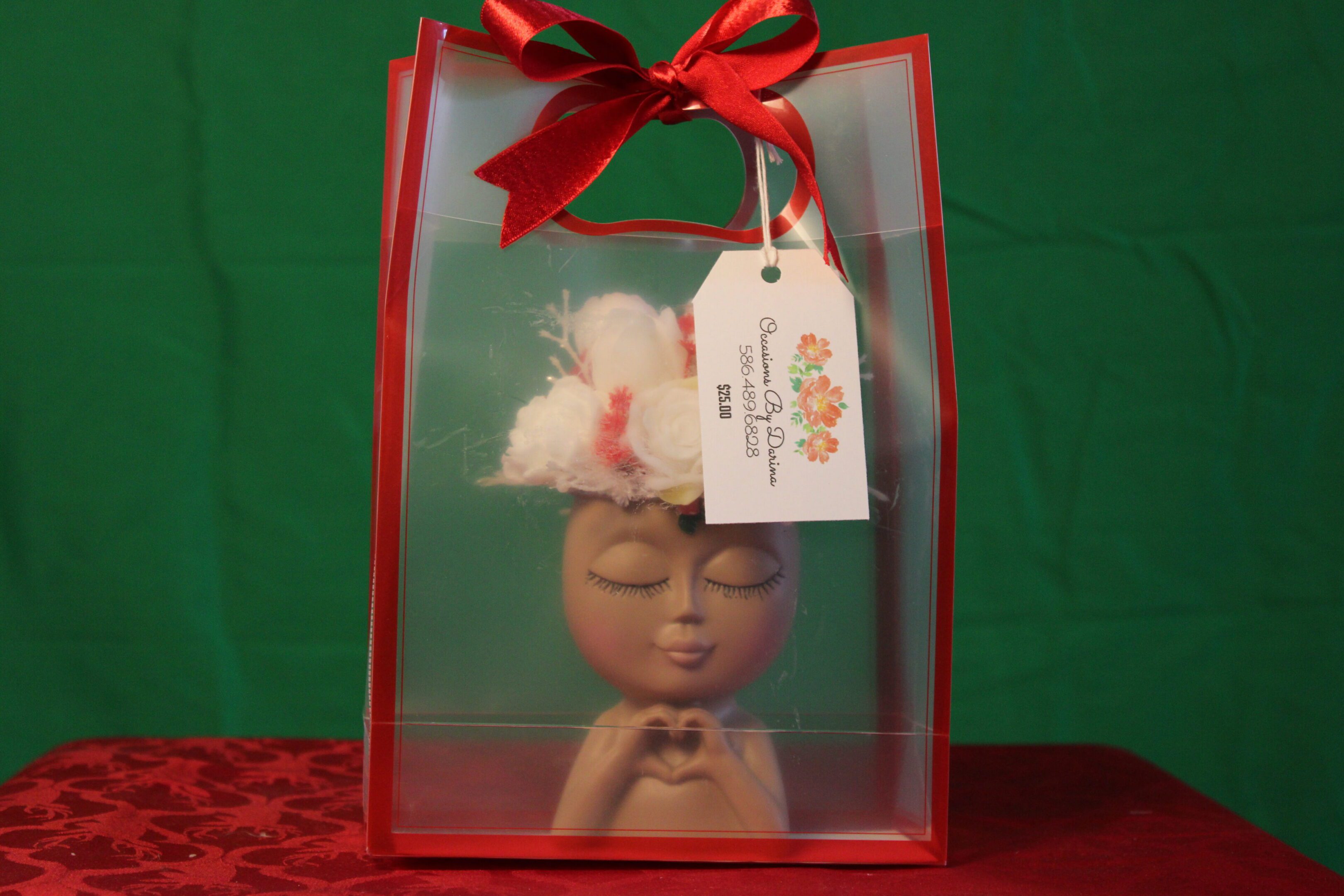 Meditative figurine in red gift bag with bow