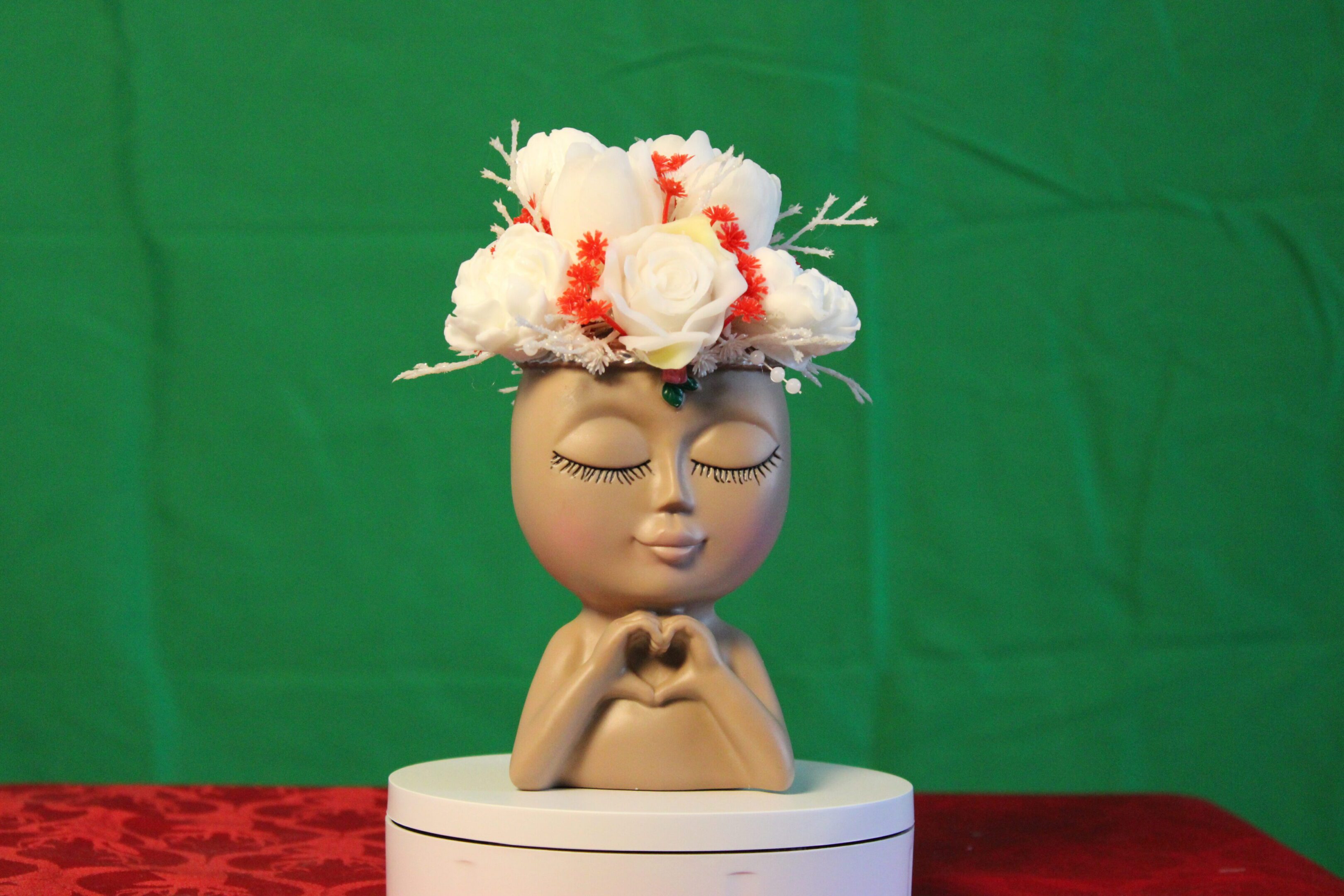 Ceramic face planter with white flower crown