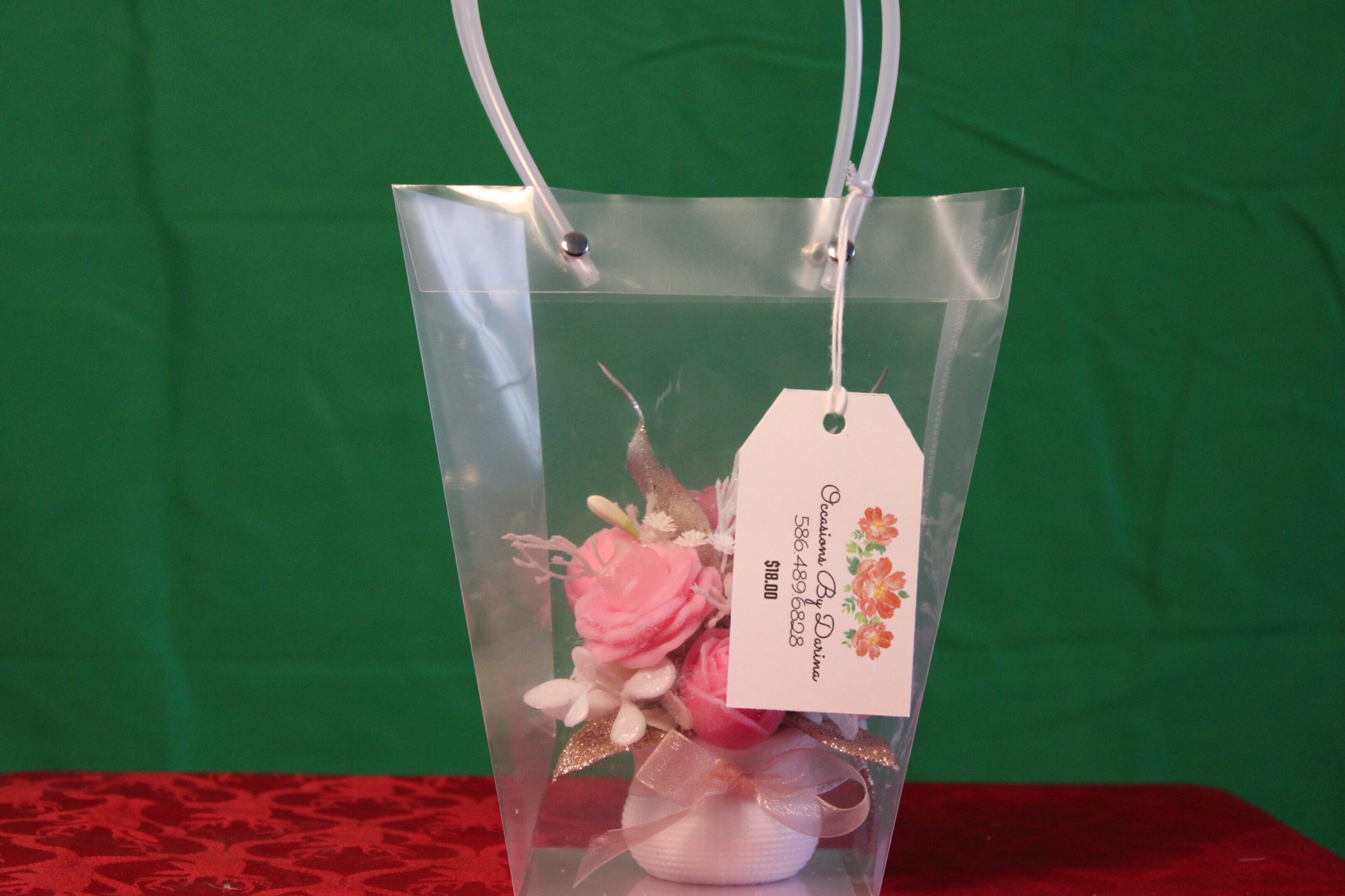 Clear gift bag with pink flower arrangement