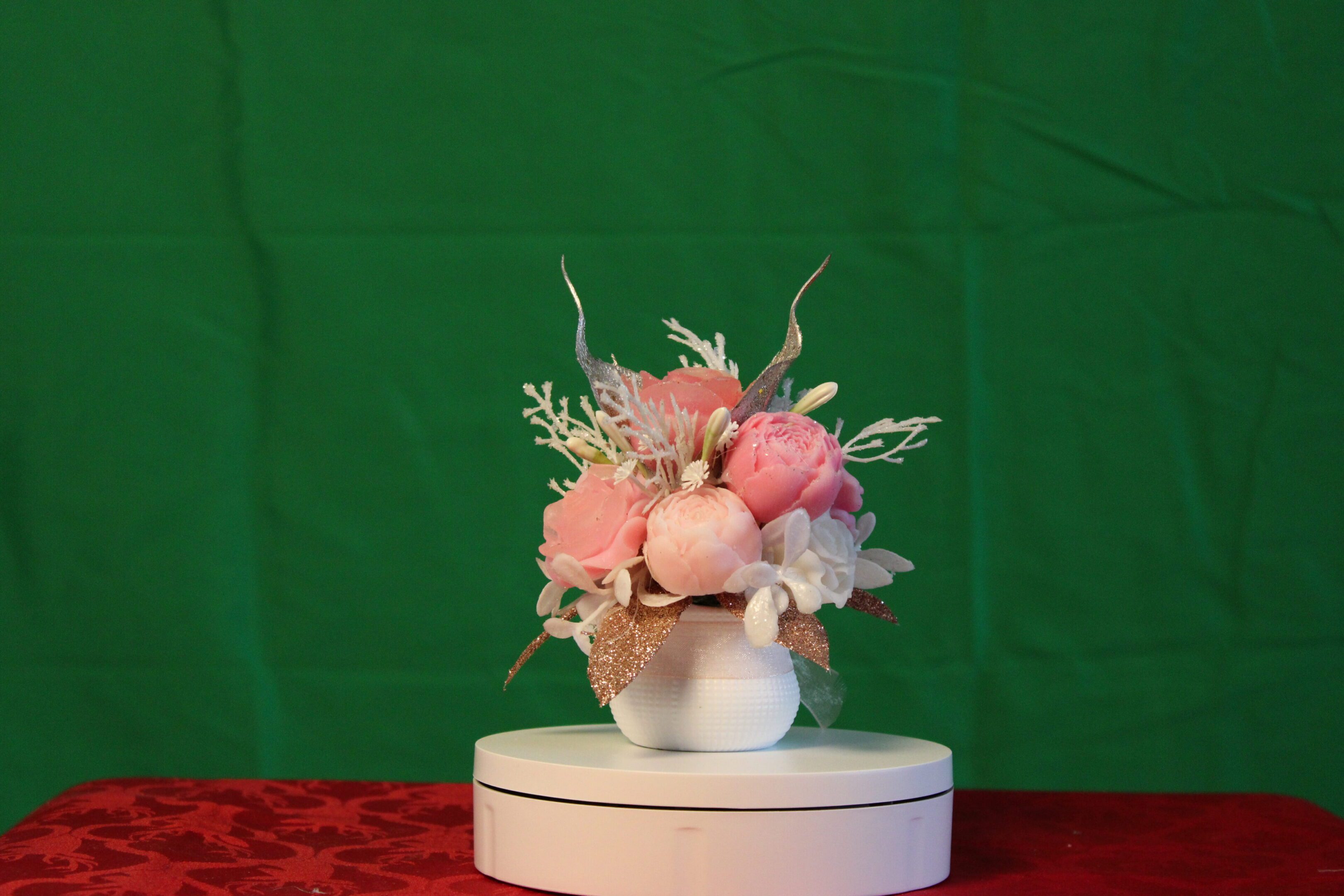 Pink floral arrangement in white vase