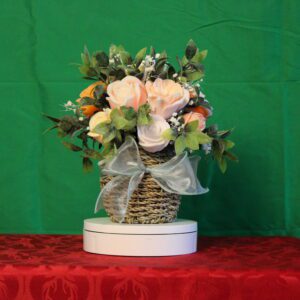 Wicker basket with pink roses and bow