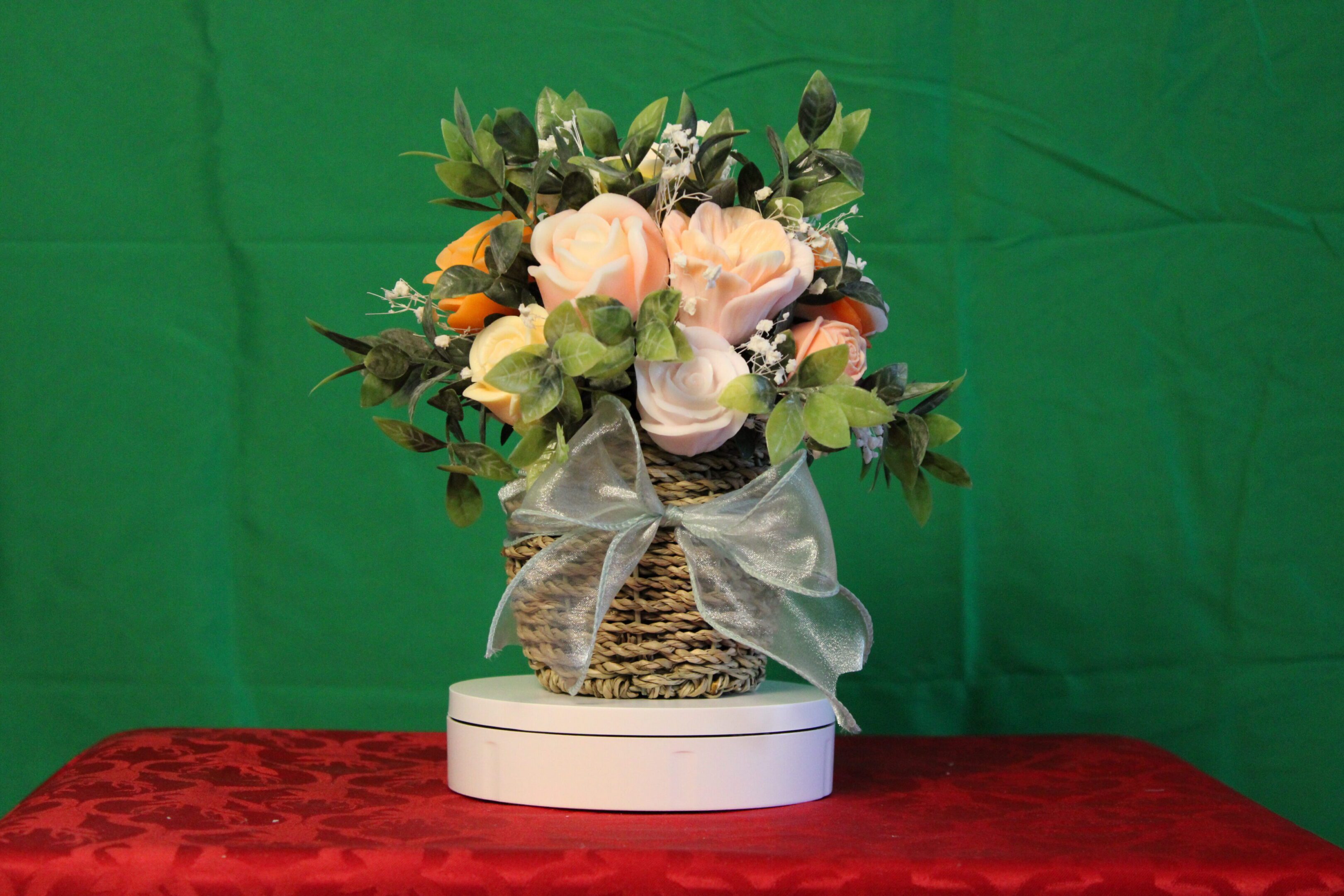 Woven basket bouquet of pink roses and greenery