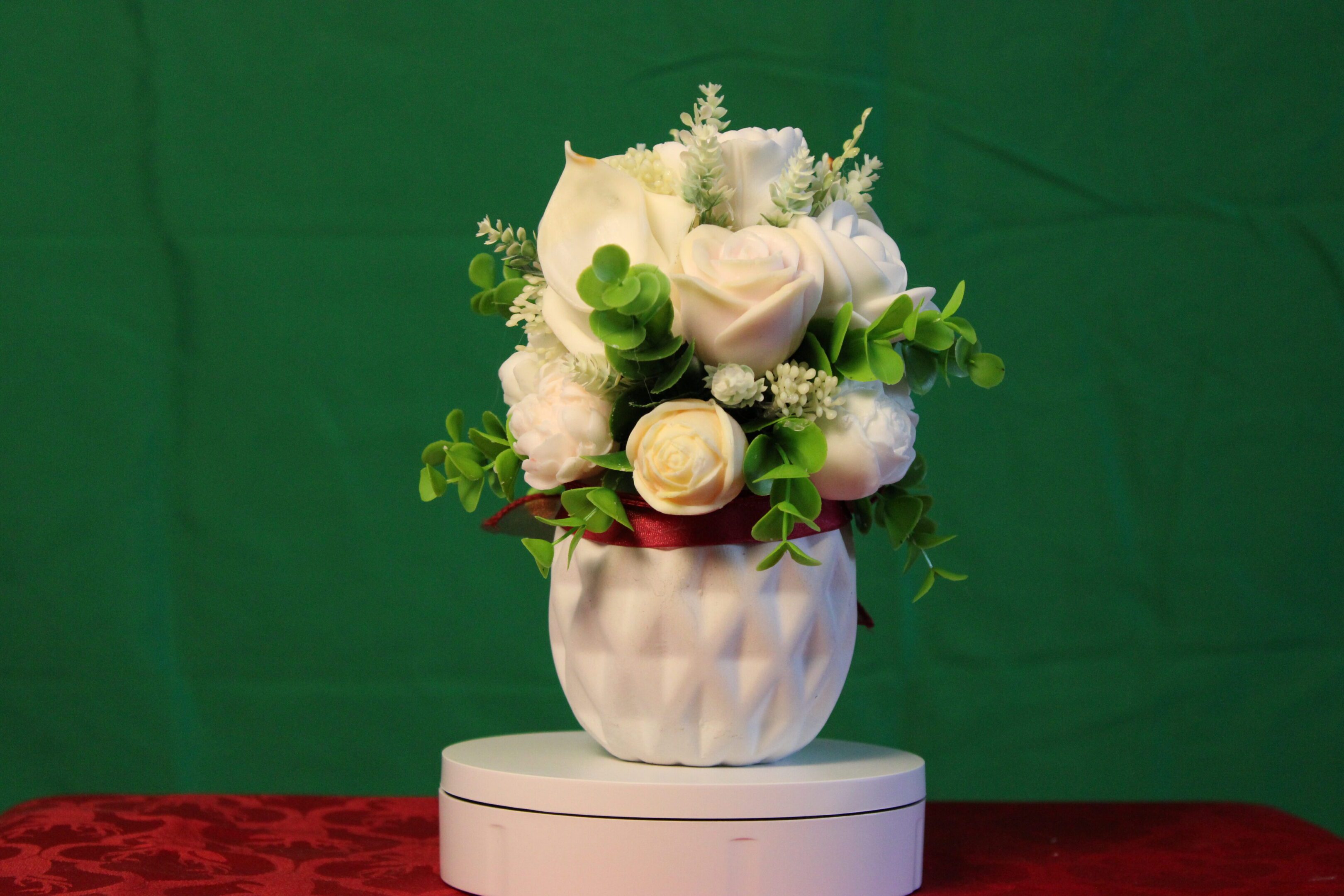 White rose bouquet with greenery in vase