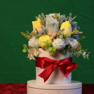 Yellow and white flower bouquet in ribboned box