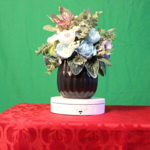 Bouquet in dark vase on red tablecloth