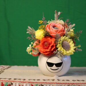 White smiley vase with colorful flowers