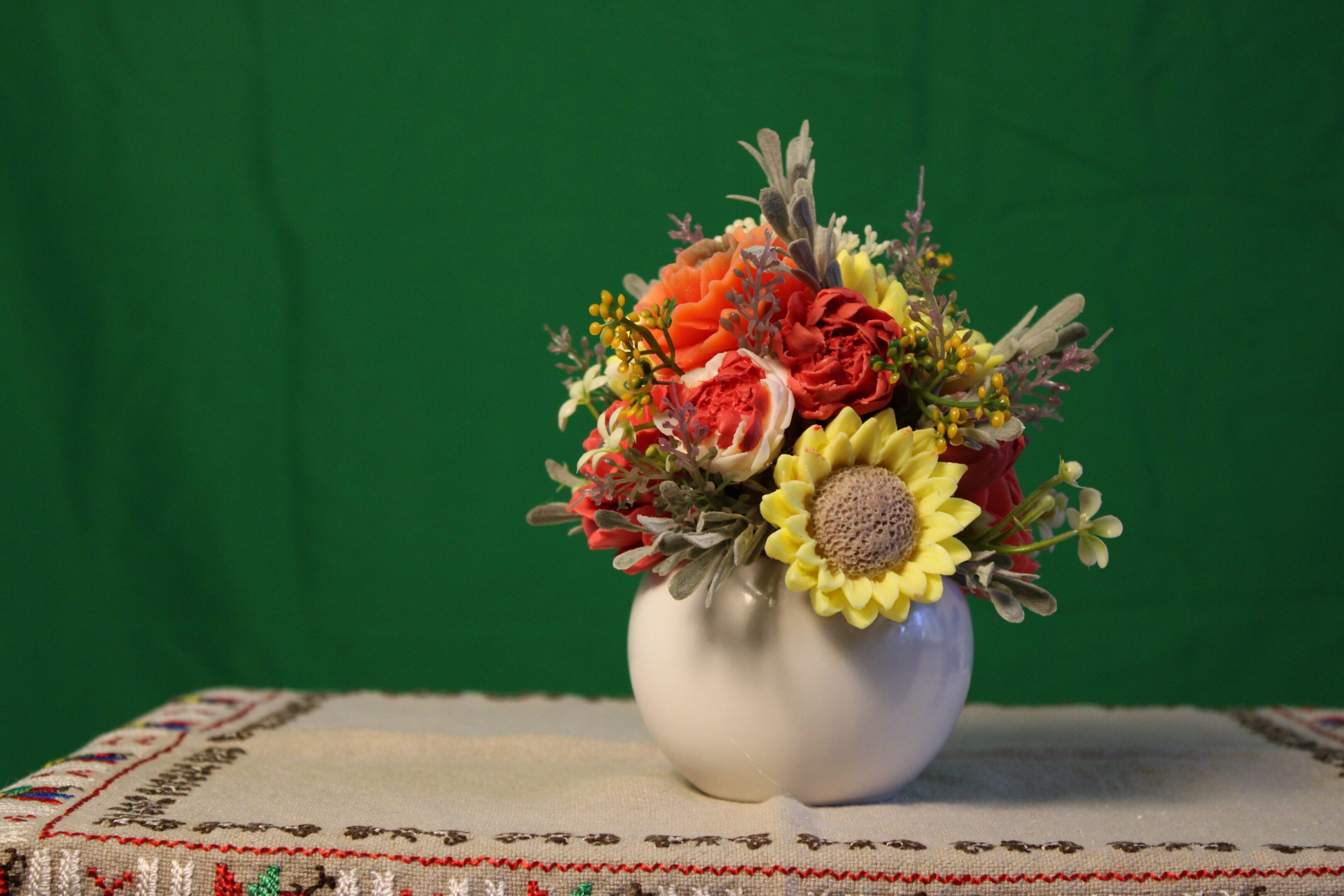 Autumn floral arrangement in white pumpkin vase