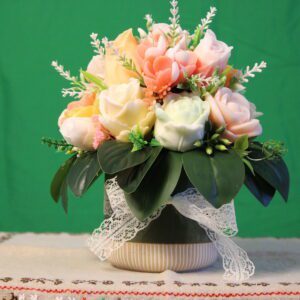 Pastel rose bouquet in lace-wrapped ceramic pot