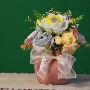 Pink vase with pastel artificial flower arrangement