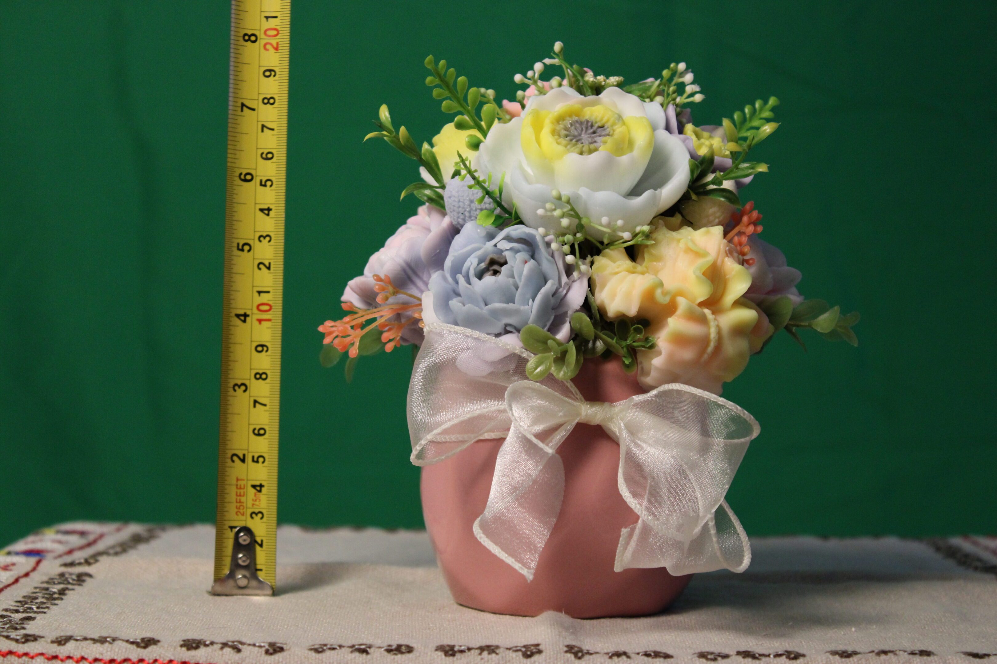 Pink ribboned vase of artificial flowers
