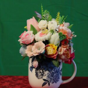 Colorful flower bouquet in patterned mug