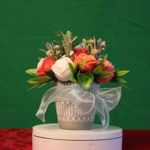 Flower arrangement in decorative vase with ribbon